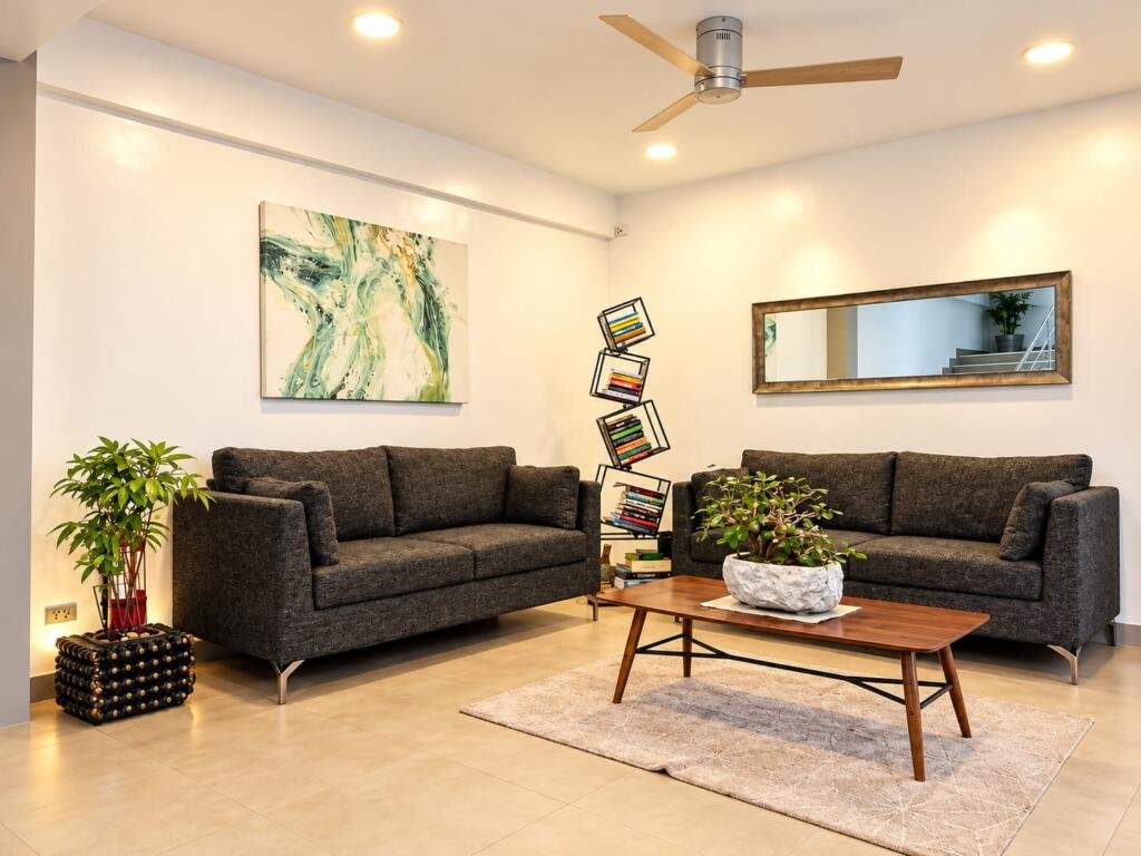Guest lounge with charcoal sofas and island artwork, Sunset Cove Beach Resort Romblon