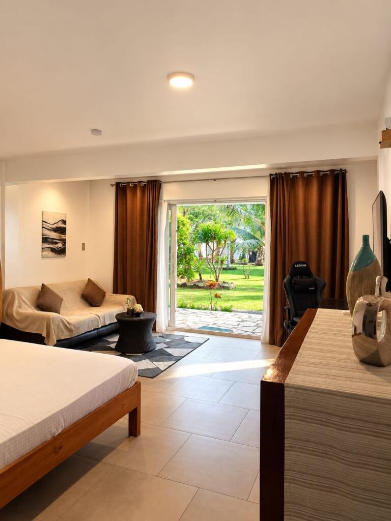Duplex Deluxe Villa Seaview room opening onto garden lawn, Sunset Cove Romblon Philippines
